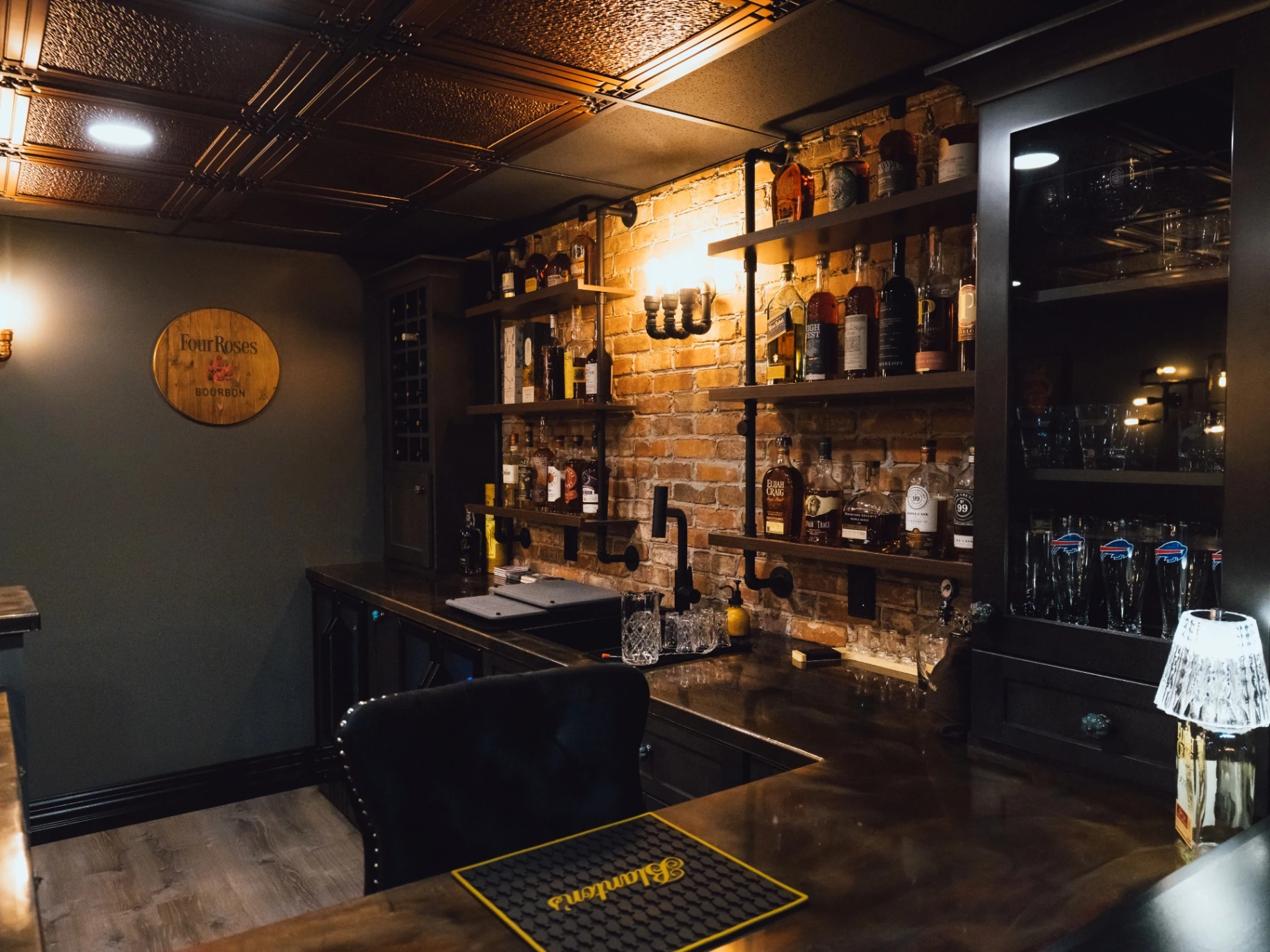 Corner view of the custom bar counter, brick wall, and shelving