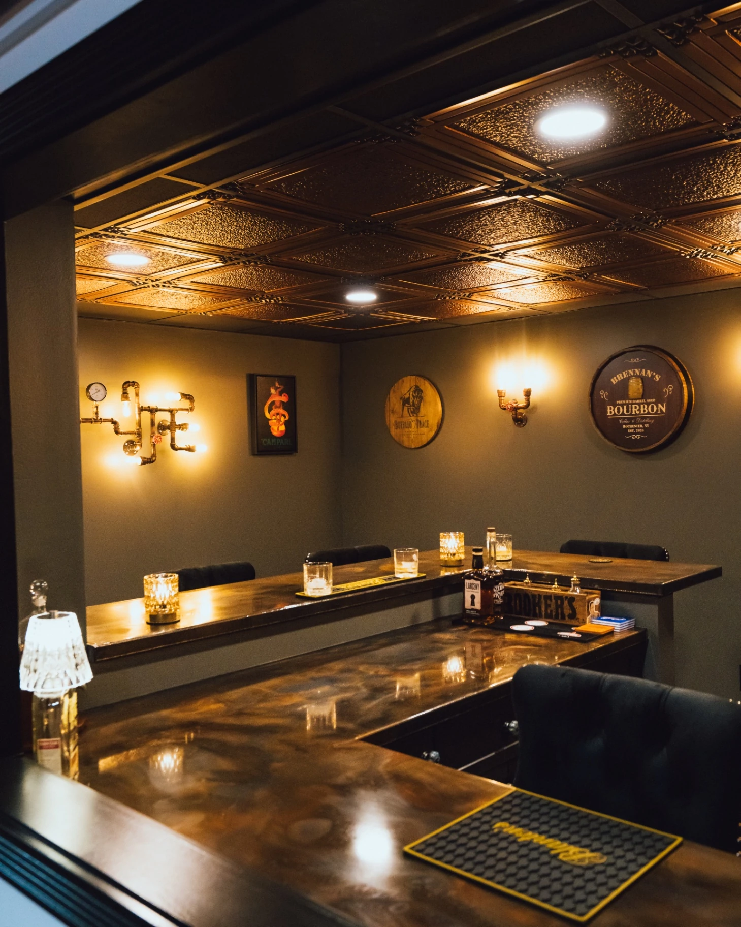 Portrait view across the custom bar counter toward the seating area and wall lighting